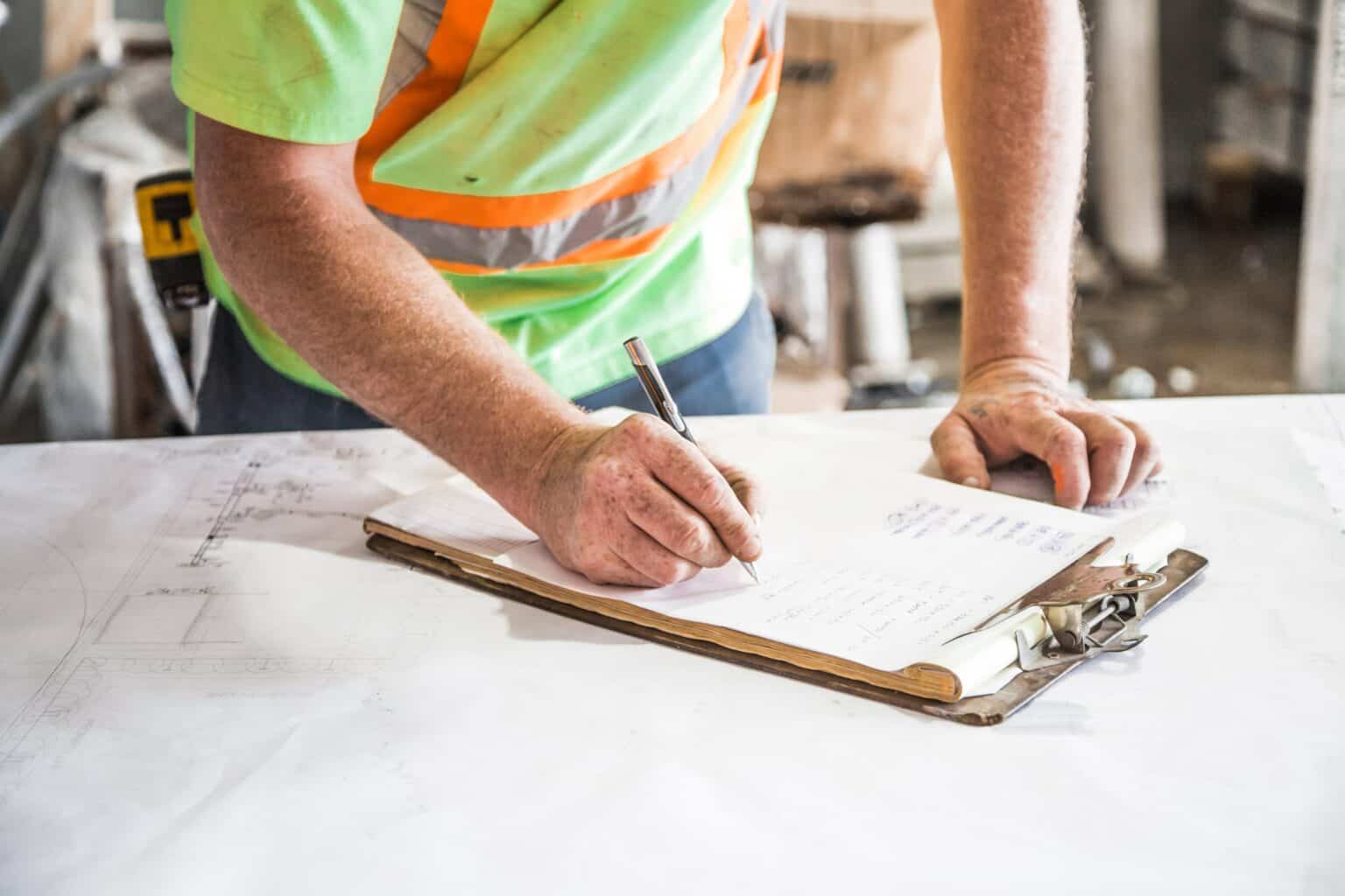 Roofing man signing papers for insurance roof claim